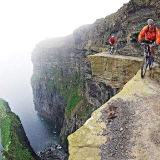 Cycling on 3 foot wide ridge 700 feet above the sea on the Cliffs of Mother, County Clare, Ireland. Photo by Victor Lucas.